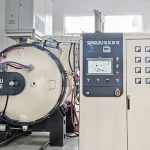 SIMUWU vacuum furnace with integrated control cabinet and front-loading furnace chamber.