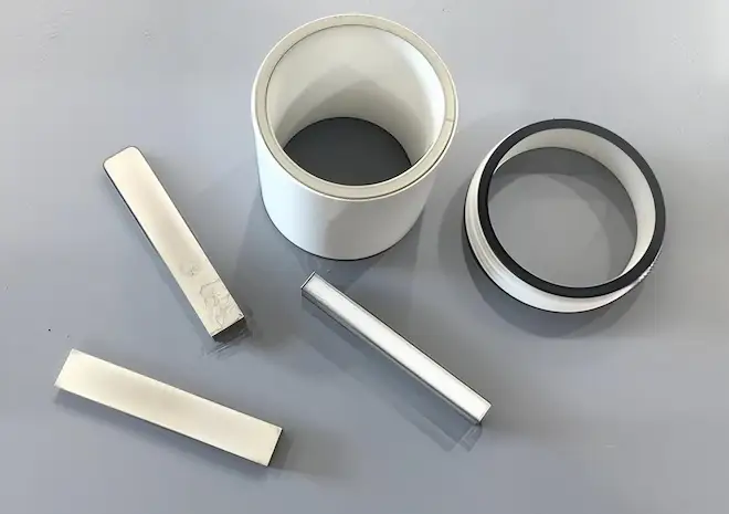 Powder metallurgy components processed in a vacuum hydrogen sintering furnace to remove oxides and achieve high density